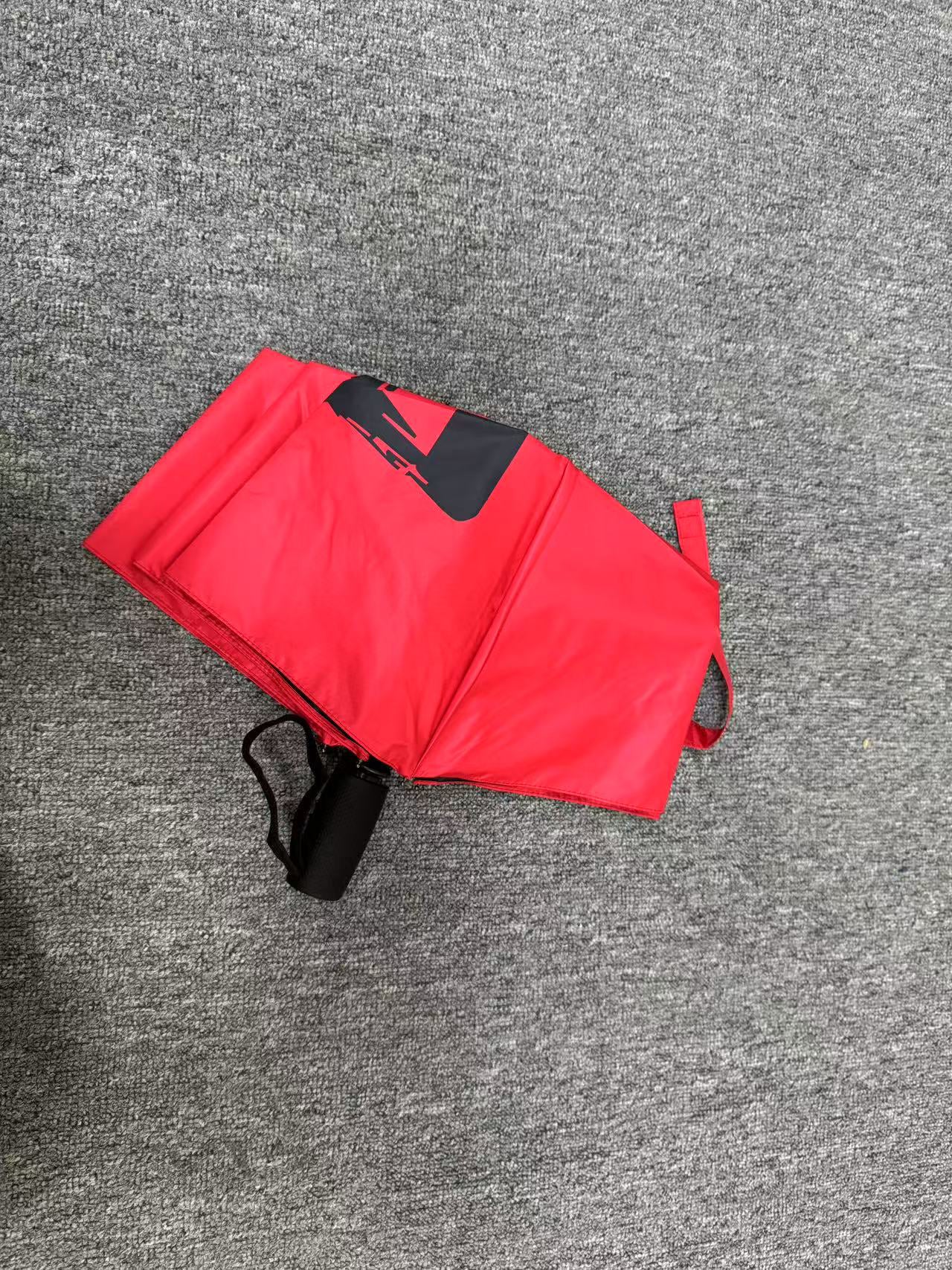 Red umbrella with 'ENOUGH!' text on a neutral background. UV coated for sun protection.
